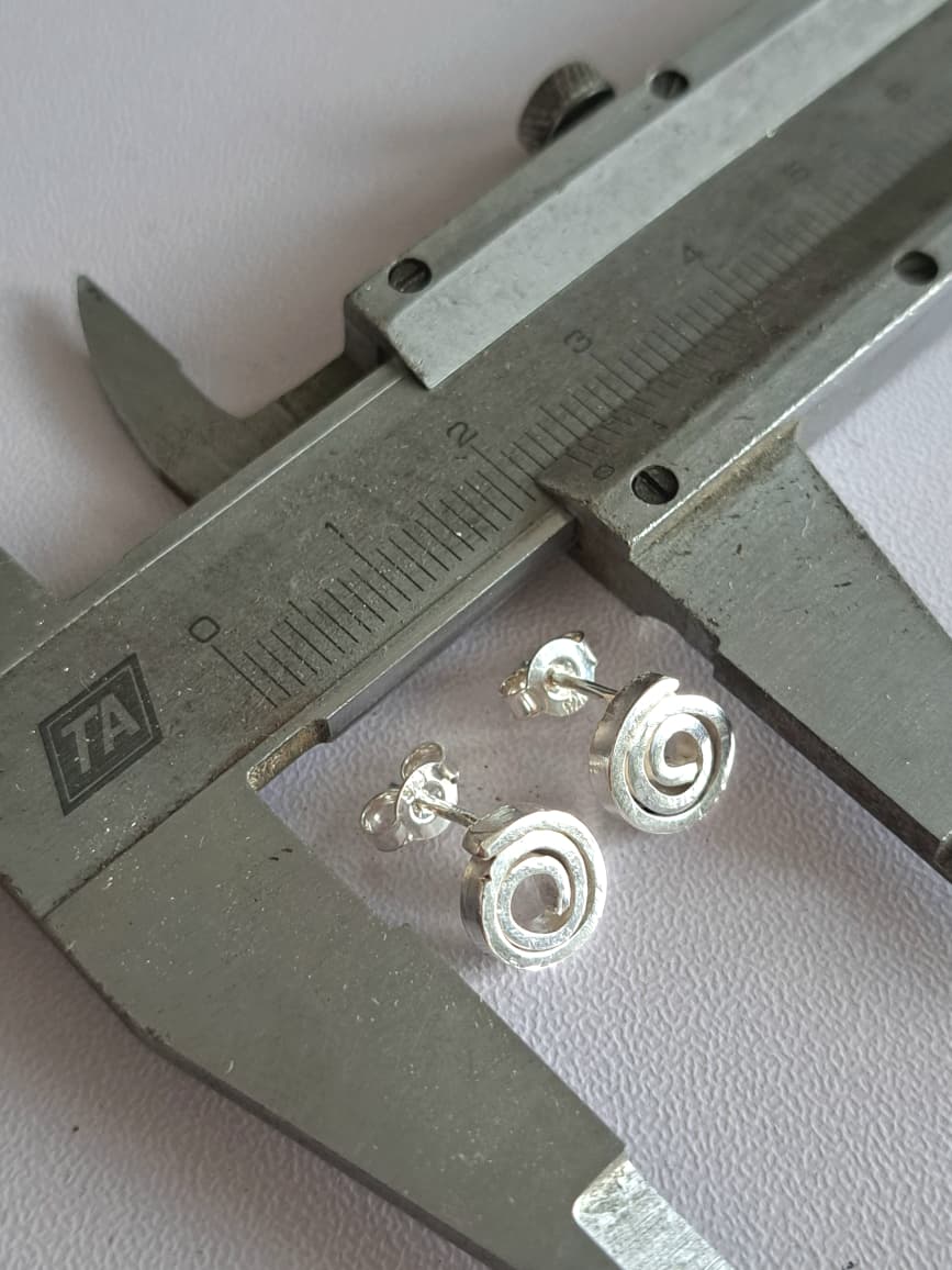 sterling_silver_spiral_2 Sterling silver spiral stud earrings shown against a measuring caliper for scale - by Two Love Design