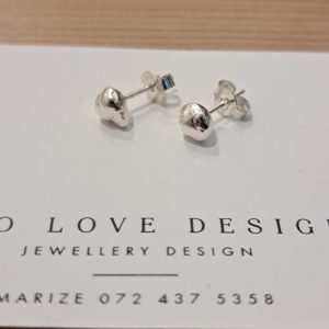 Side view of sterling silver nugget stud earrings showing organic surface texture